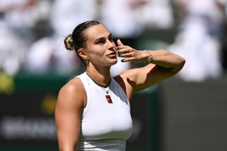 Aryna Sabalenka blows a kiss to the crowd after winning a tennis match.