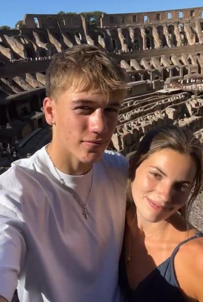 Couple posing for a selfie at the Colosseum in Rome.