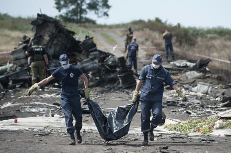 Emergency workers carrying a body bag at the Malaysia Airlines Flight MH17 crash site.