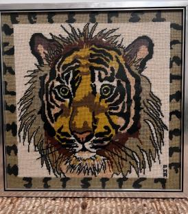 Needlepoint of a tiger's face.