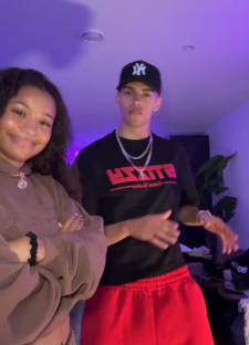 Young man and woman posing indoors.