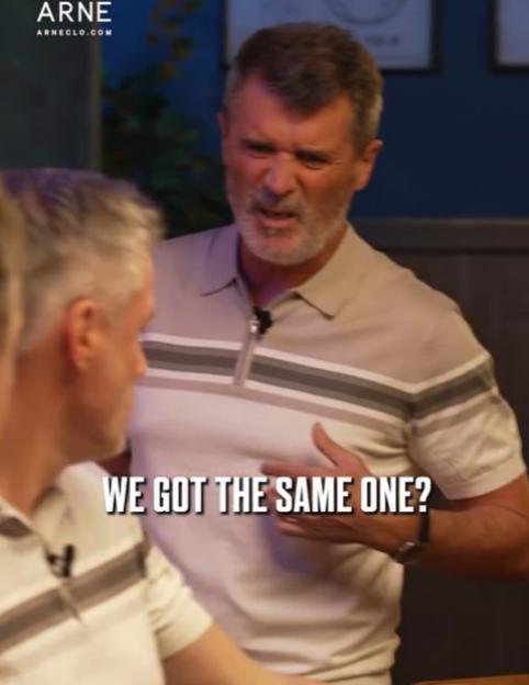 Roy Keane grimacing while wearing a striped polo shirt.