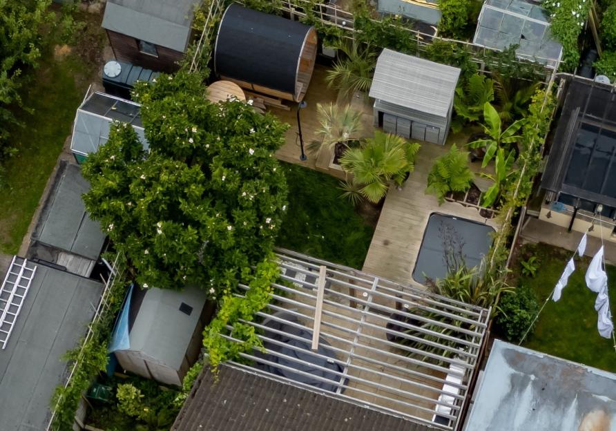 Aerial view of a garden with a hot tub and sauna.