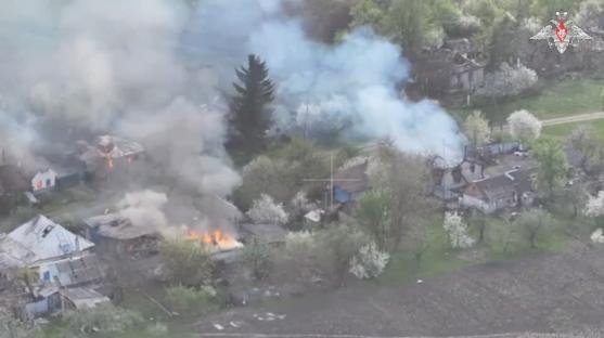 Aerial view of burning buildings in a village.