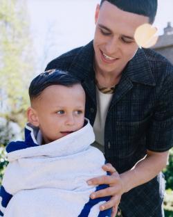 Phil Foden with his son wrapped in a towel.