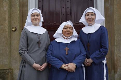 Three nuns posing for a photo.