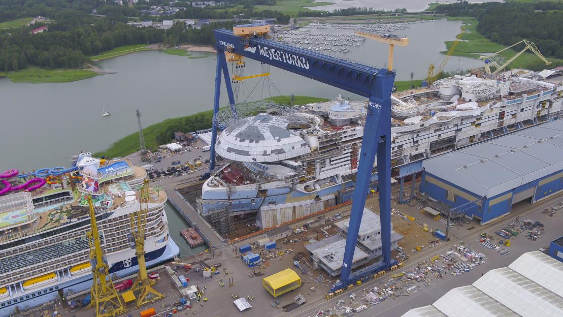 Aerial view of the Legend of the Seas cruise ship under construction in a shipyard.