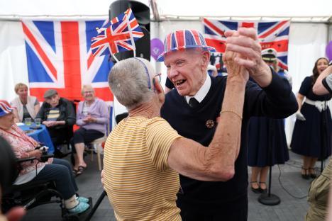 Veteran Jim Bowes dancing with a staff member at a VE Day tea party.