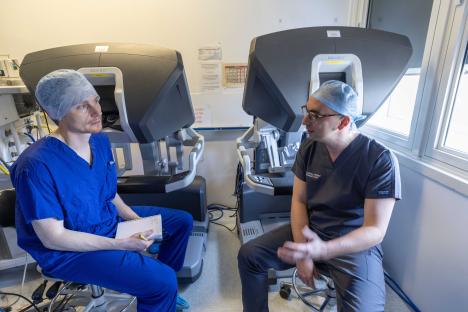 A journalist interviews a surgeon using robotic keyhole surgery.