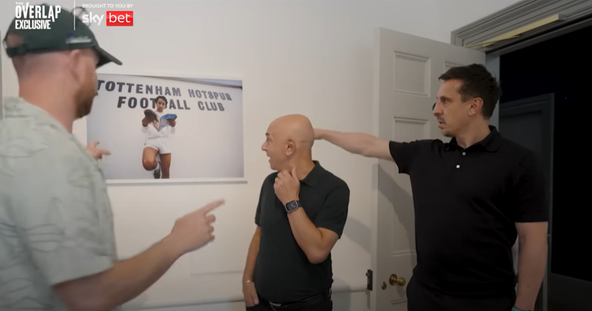 Three men reacting to a framed photo of a Tottenham Hotspur Football Club player.