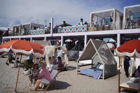 Spectators at a Formula One race on a man-made beach.