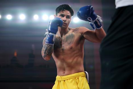 Ryan Garcia at a media workout, wearing boxing gloves.