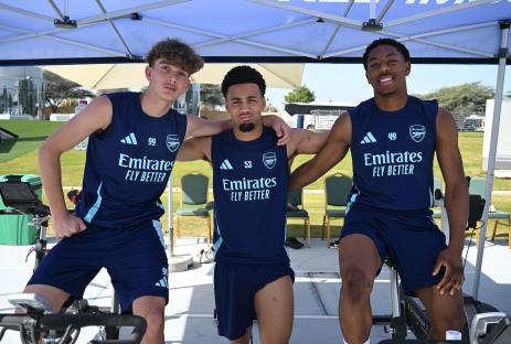 Three Arsenal youth players on stationary bikes during training.