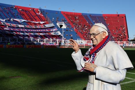 Statue of Pope Francis at a soccer stadium.
