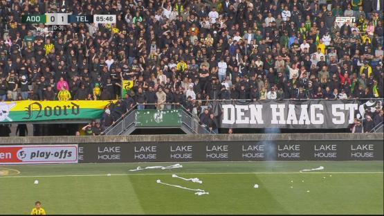 Soccer fans in the stands during a game.