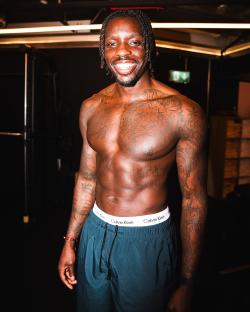 Portrait of a smiling muscular man with tattoos.