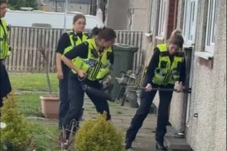 Hilarious moment bumbling cops struggle to break down door as mocking neighbours shout ‘go on… knock it!’