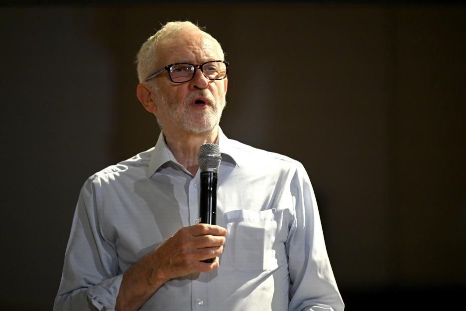 Jeremy Corbyn speaking into a microphone.