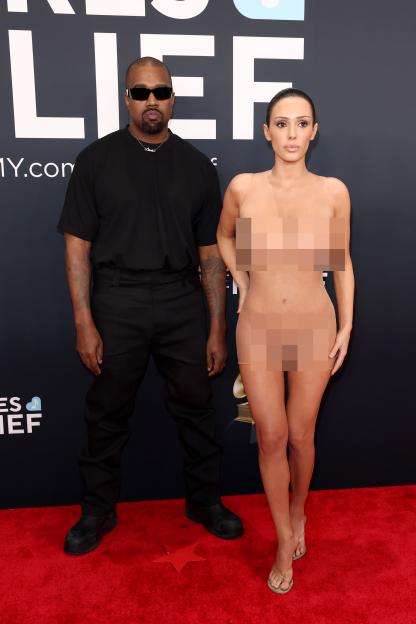Kanye West and Bianca Censori pose on a red carpet at the 67th Annual GRAMMY Awards.