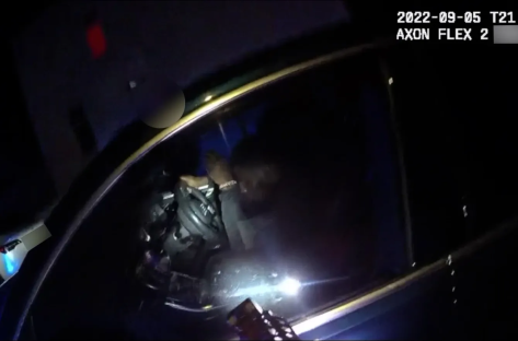 Person restrained in a car at night.