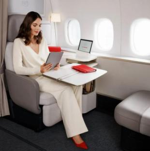 Woman using tablet in Air France Premier Suite.