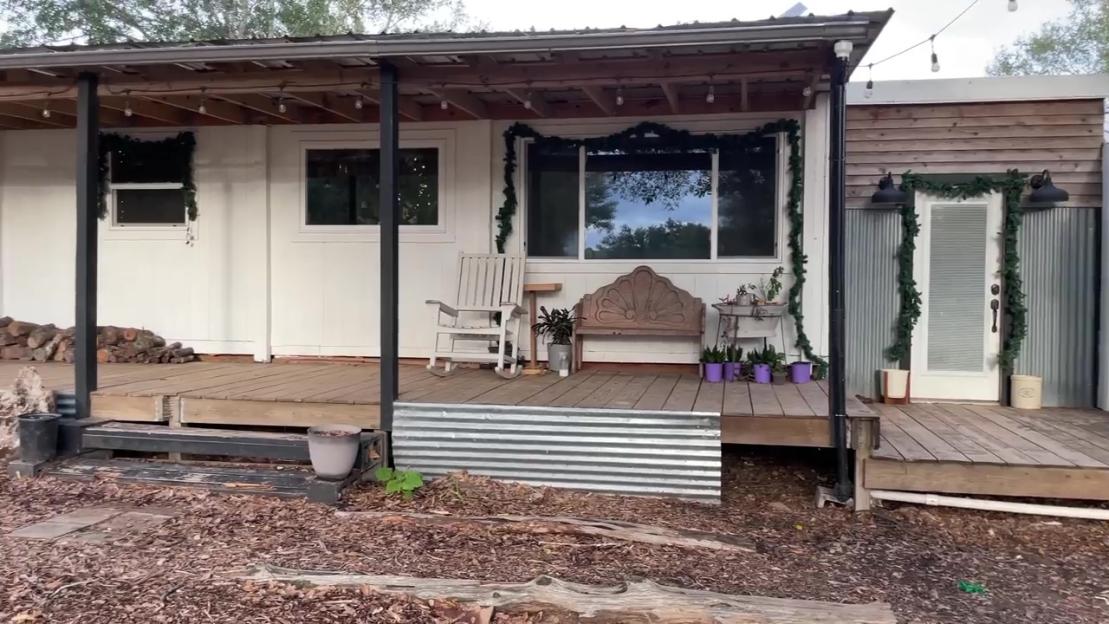 Family's small home with porch and deck.