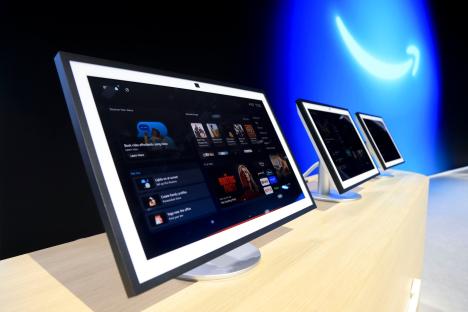 Tablets displaying the new Alexa interface at an Amazon event.