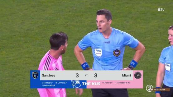 Lionel Messi arguing with a referee during a soccer game.