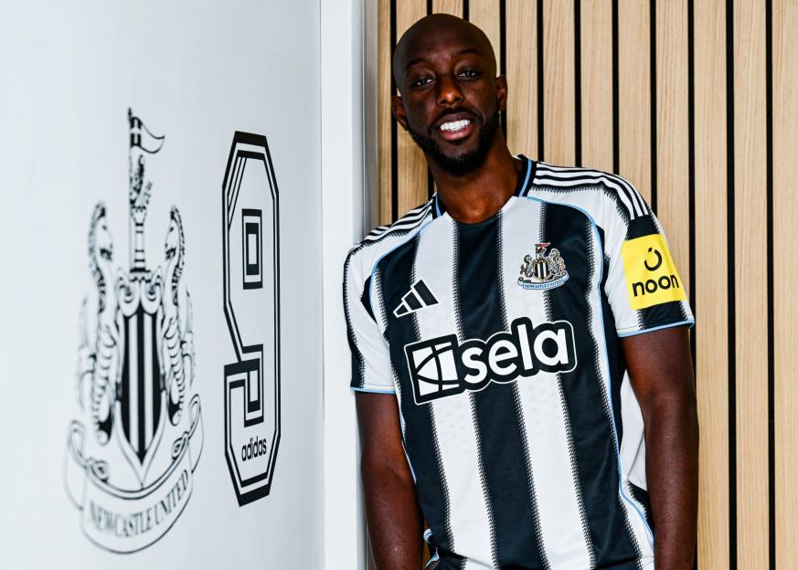 NEWCASTLE UPON TYNE, ENGLAND - SEPTEMBER 01: Yoane Wissa poses for photographs next to a number 9 graphic at the Newcastle United Training Centre after signing for the club on September 01, 2025 in Newcastle upon Tyne, England. (Photo by Serena Taylor/Newcastle United via Getty Images)