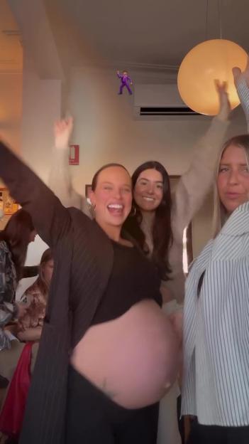 Pregnant woman celebrating with friends.