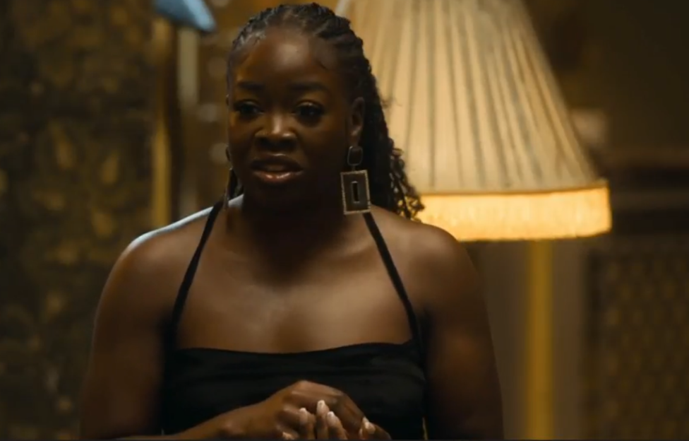 Woman with dark skin and braids looking concerned.