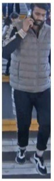 CCTV image of a man on a phone, potentially a witness to a sexual assault.