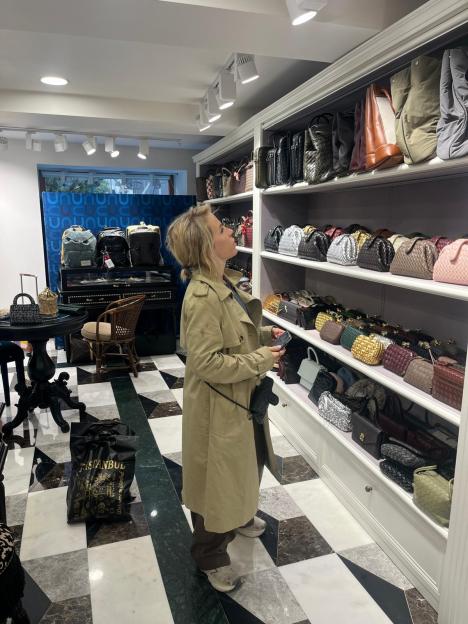 Clemmie Moodie inspecting handbags in a shop selling replicas in Istanbul.