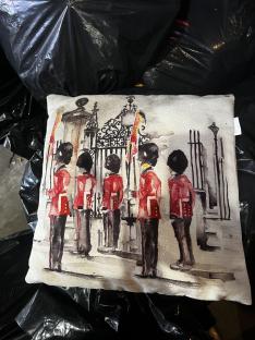 Illustration of a cushion depicting guardsmen at a gate.