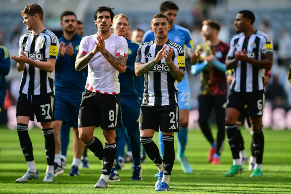 Soccer players clapping for fans.