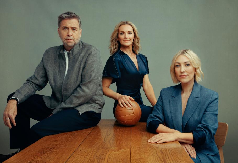 Portrait of three people sitting at a wooden table with a vintage football.