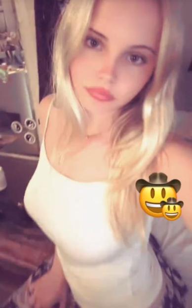 Mary Glen in a white tank top.
