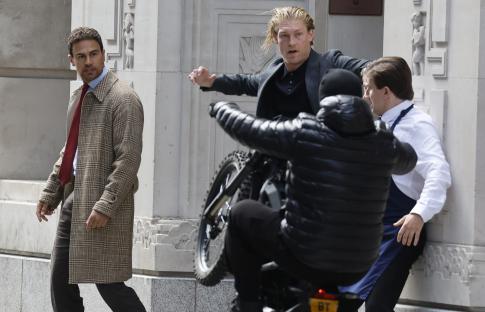 Behind-the-scenes photo of Vinnie Jones and Theo James filming a scene.