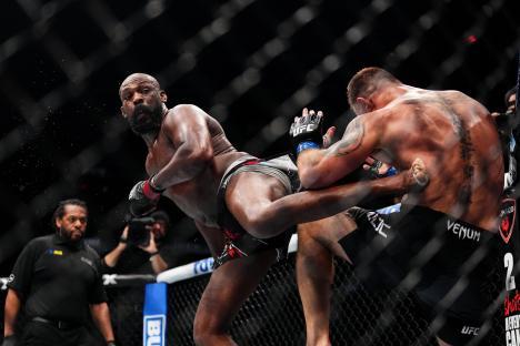 Jon Jones kicking Stipe Miocic in a UFC fight.