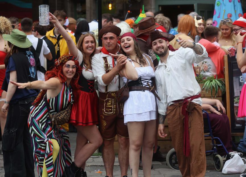 Group of people in costume at a pub crawl.