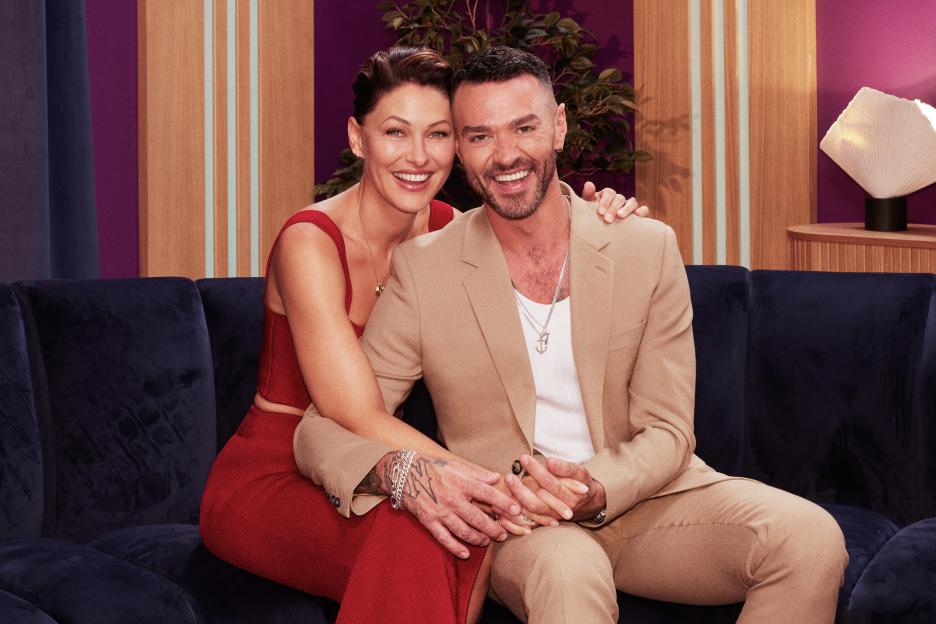 Emma Willis and Matt Willis sitting on a couch.