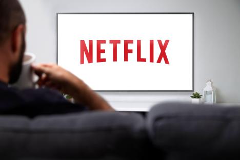 Man watching Netflix on a smart TV.