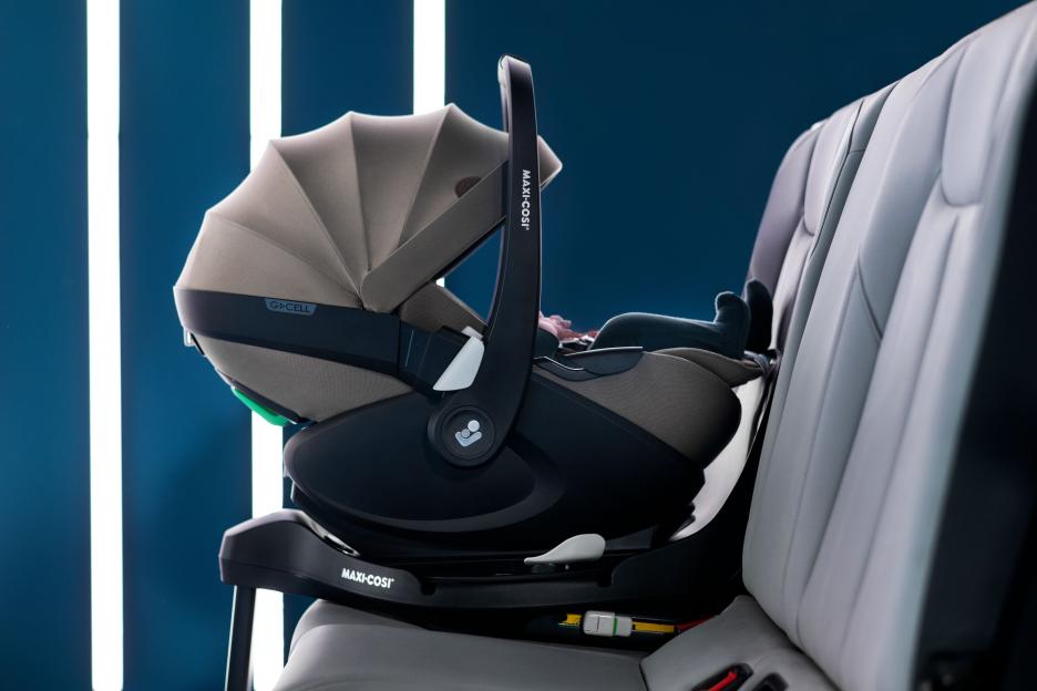 Infant car seat installed in a vehicle.