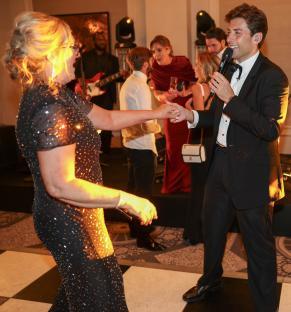 James Argent singing at a charity event.