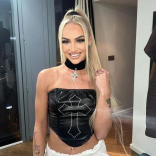 Alisha Lehmann wearing a black corset top and cross necklace.