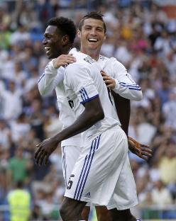 Cristiano Ronaldo and Emmanuel Adebayor of Real Madrid celebrating a goal.