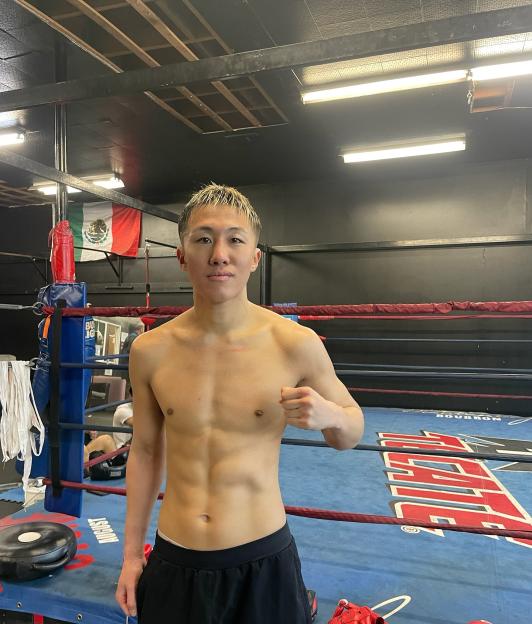 Shirtless boxer in a boxing gym.