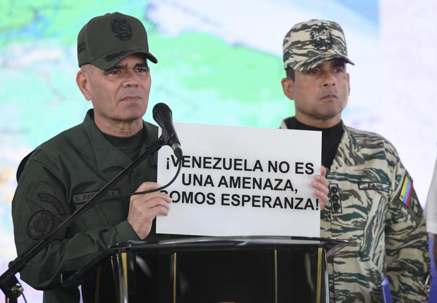 Venezuela's Defense Minister Vladimir Padrino Lopez holds a sign that reads "Venezuela is not a threat, we are hope."