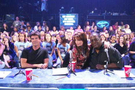 American Idol judges Simon Cowell, Paula Abdul, and Randy Jackson at the judges' table.