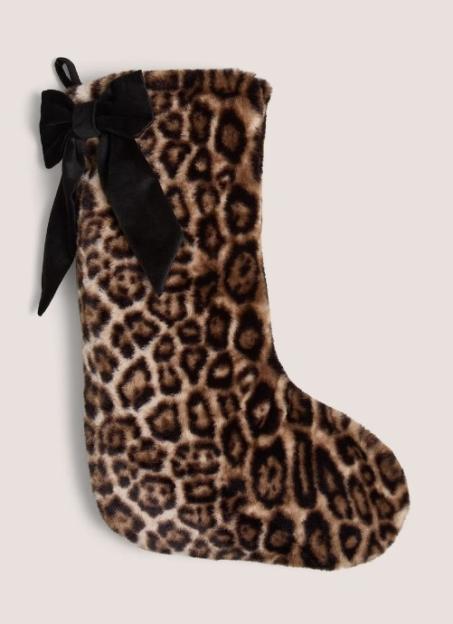 Leopard print Christmas stocking with a black bow.